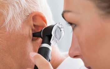 Dr examining mans ear