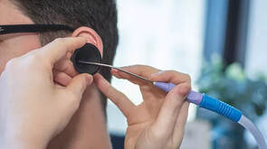 Dr using microsuction on ear